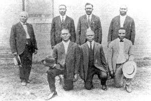 Six of the 12 Black sharecroppers sentenced to death pose with their lawyer Scipio A. Jones, left. — Ed Hicks, Frank Hicks, Ed Moore, J. C. Knox, Ed Coleman, and Paul Hall