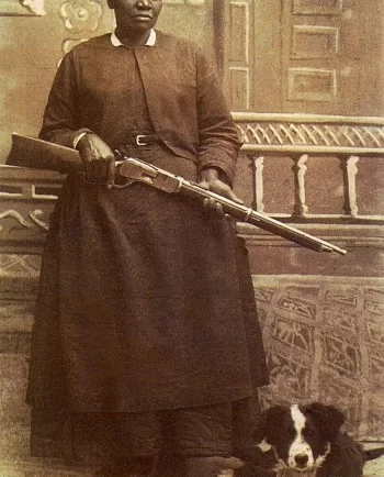 Stagecoach Mary Fields holding her shotgun standing next to her dog